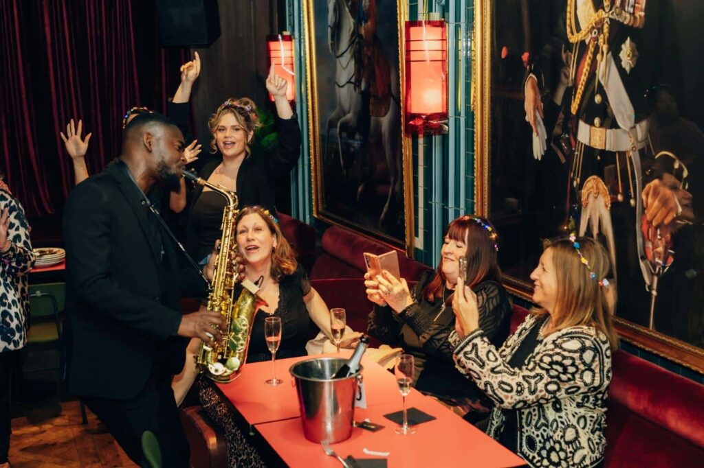 Temitope Oladipupo: Saxophonist performing at lively party.